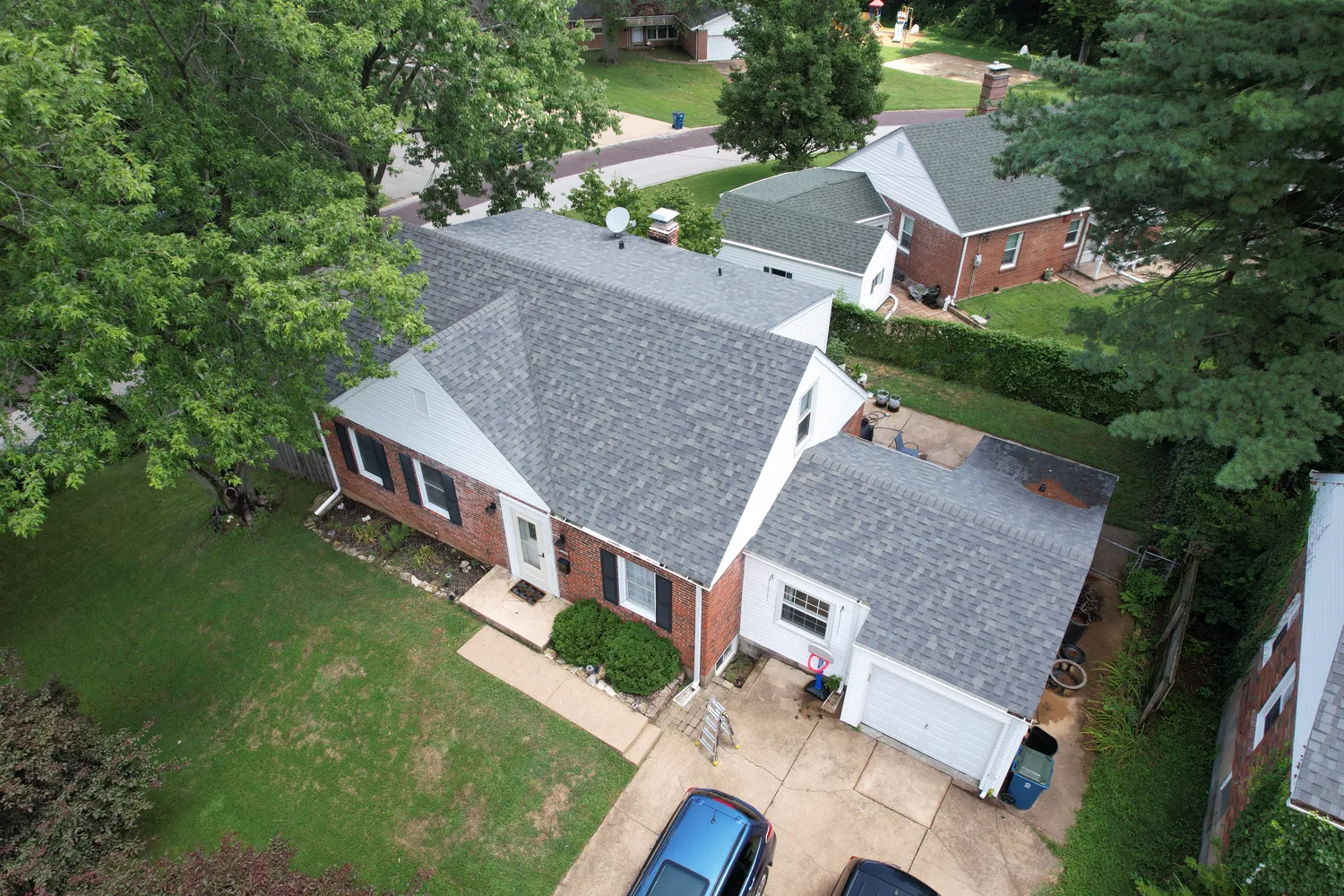 Completed shingle roof on a large brick home in the St. Louis area