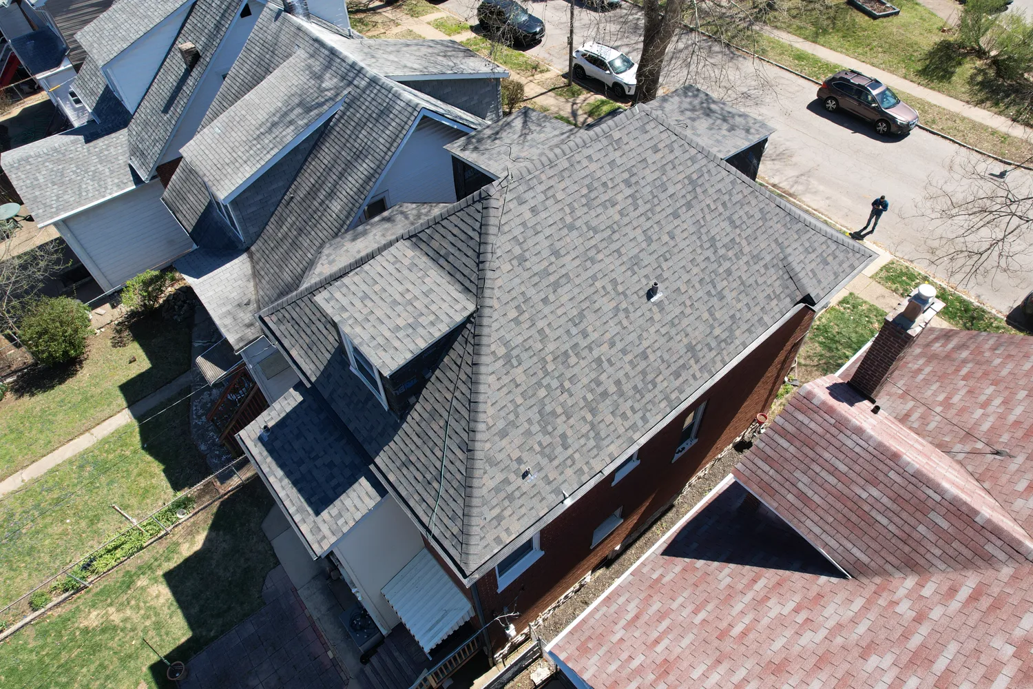 Completed gray architectural-shingle roof on a two-story brick St. Louis home