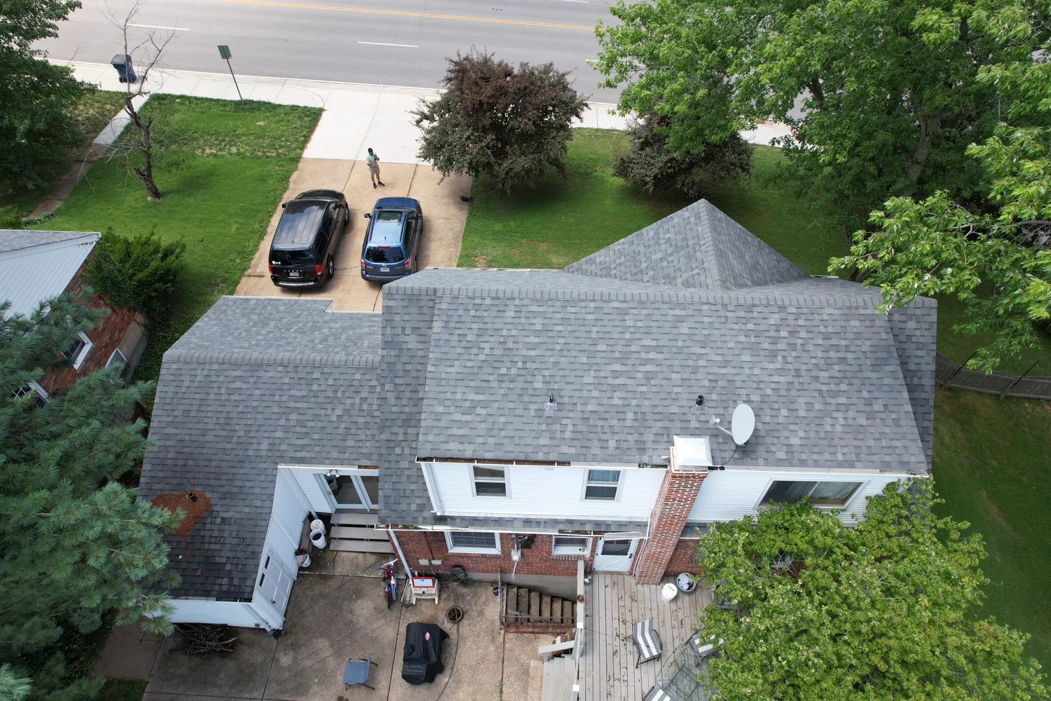 Completed gray architectural-shingle hip roof on a St. Louis-area home